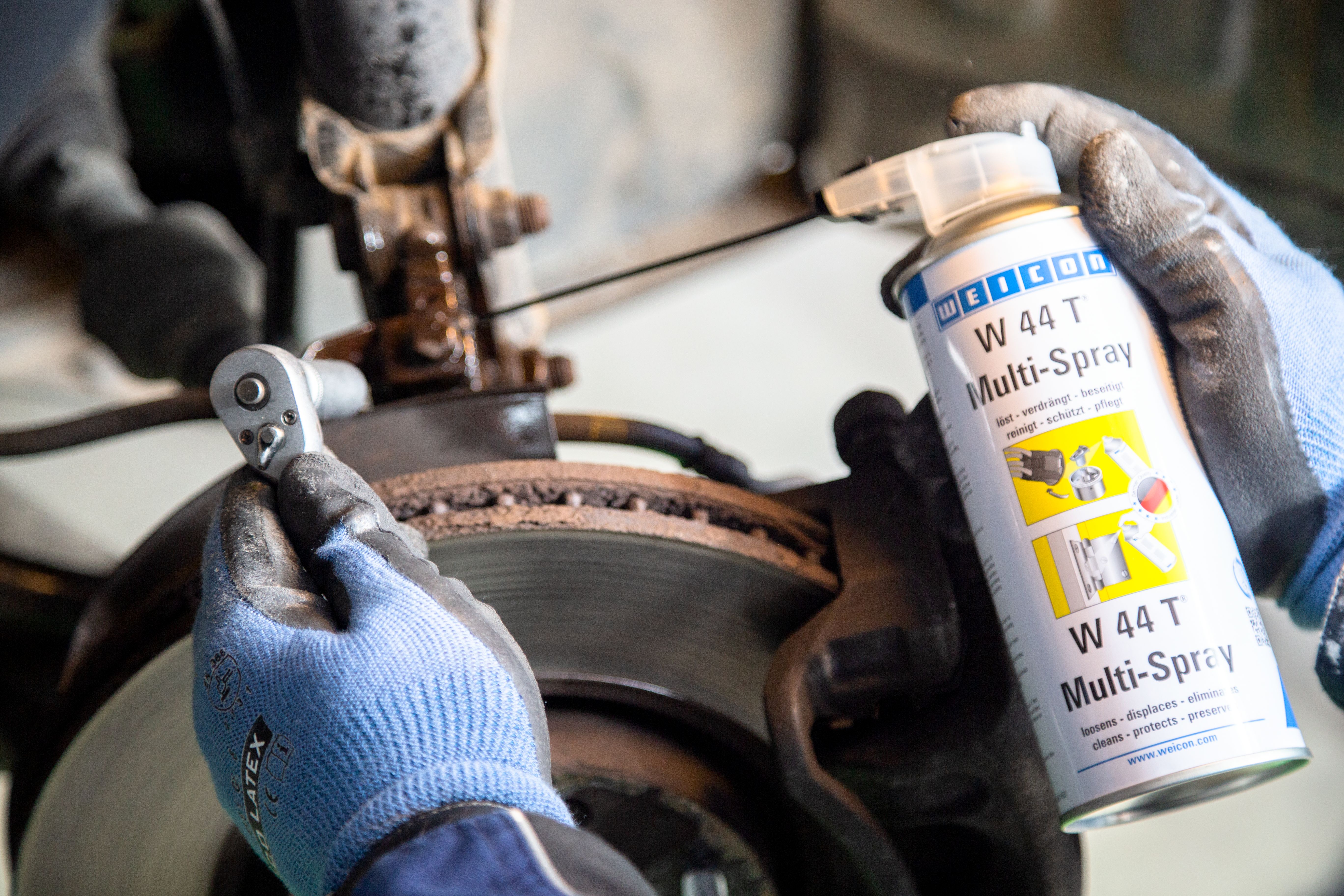 W44T multi-purpose spray is applied to a metal part
